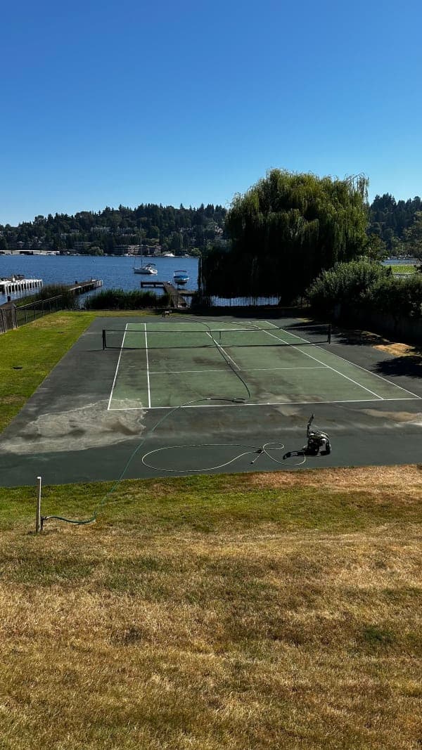 Before: cracked and worn court surface needing resurfacing