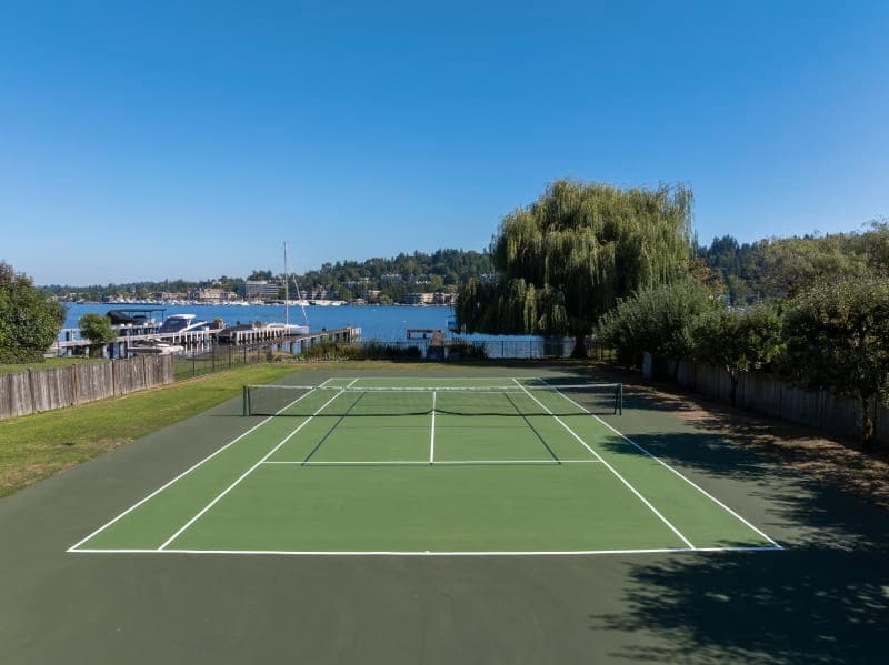 Aerial view of beautifully resurfaced tennis court with vibrant blue and green colors